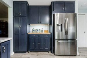 Kitchen with colorful cabinets, including a bright island and pastel tones.