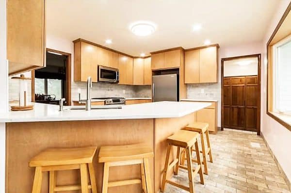 Kitchen with wood details and a countertop used as an eating area