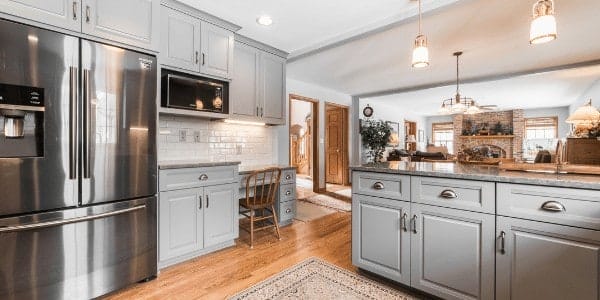 Kitchen remodel with modern grey cabinets and other design features.