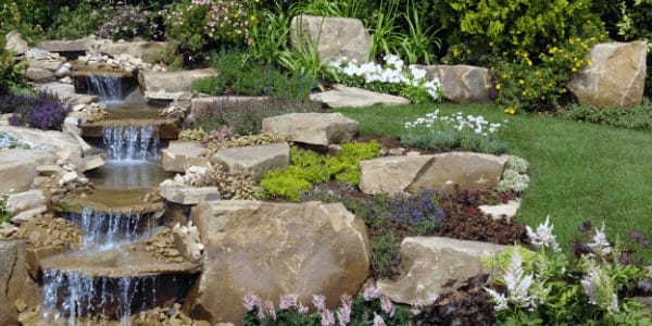 Backyard water feature enhances an outdoor living space in Northern Illinois.