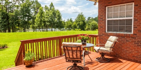 Deck remodel overlooking a green lawn.