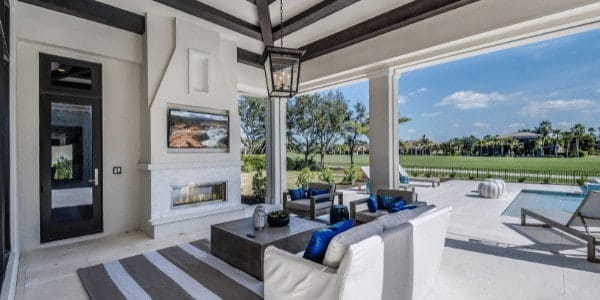 Outdoor living room that opens to a patio with inground spa by Spears Design Build Group.