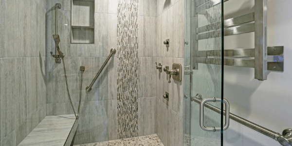 ADA accessibility bathroom remodel with walk-in shower with safety bars.
