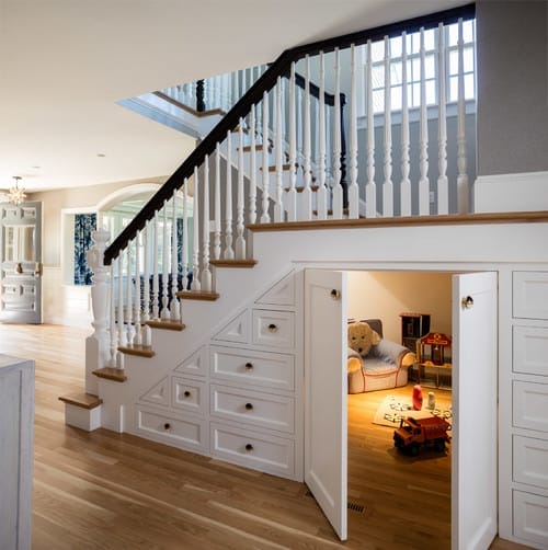 A home remodel to create a playroom design under the main staircase. 