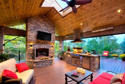 Indoor-outdoor living space with roof and fireplace, full glass walls, and easy access to the deck.