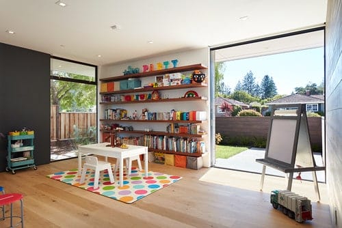 Interior of a second story kids playroom with large windows offering abundant sunlight.