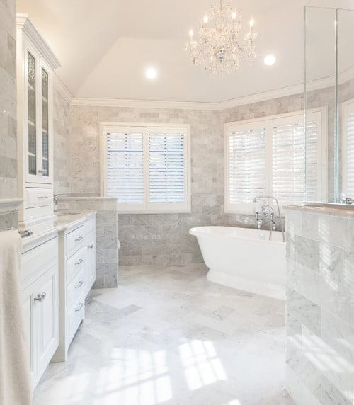 Timeless elegance marble master bath with many bathroom storage solutions.