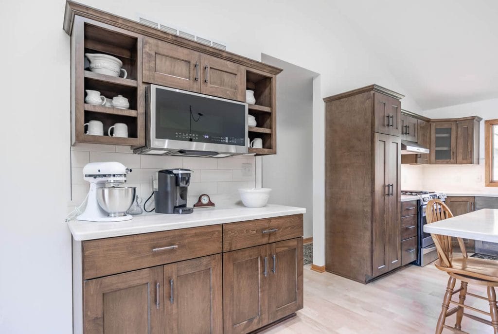 Kitchen remodel with brown cabinets with a caption reading "TImeless."