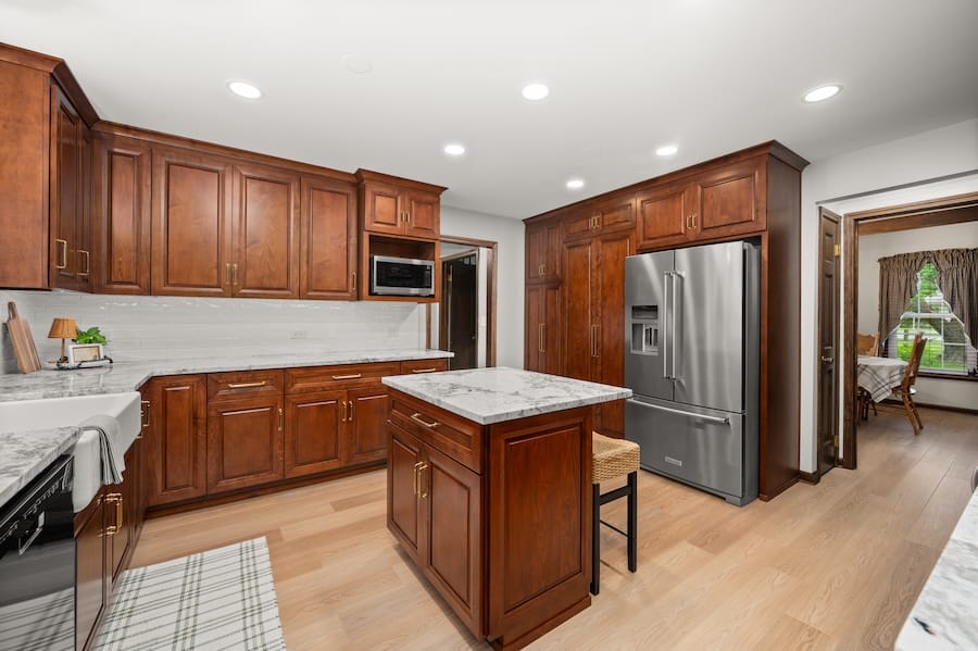 Open view of kitchen with fridge in view