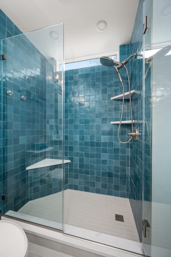 Guest hallway bathroom with new blue tiling.